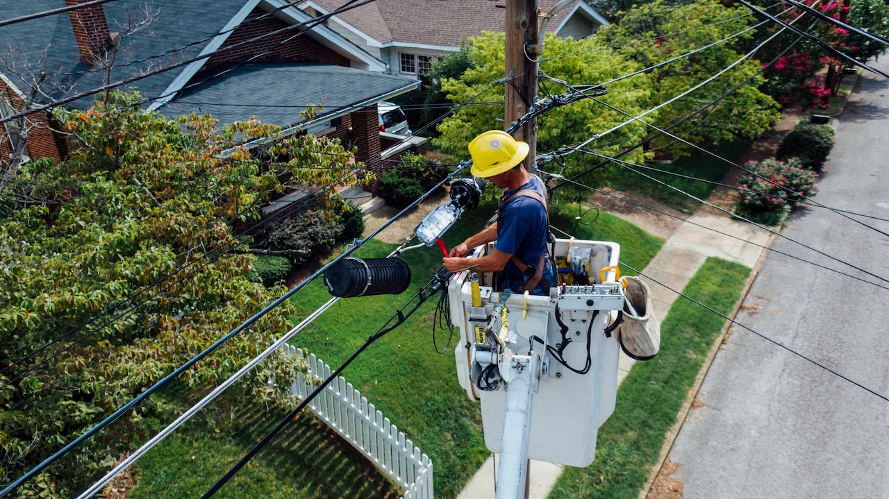 electrician fixing power lines